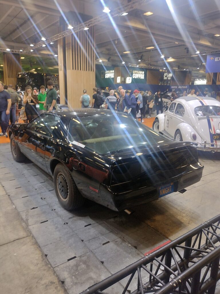 Paris motor show 2024 with black car and beetle beside
