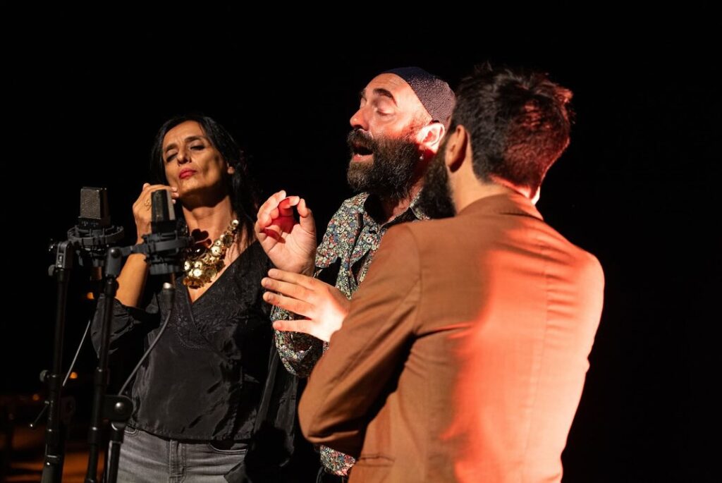 Three people perform at the polyphonic festival in corsica sep