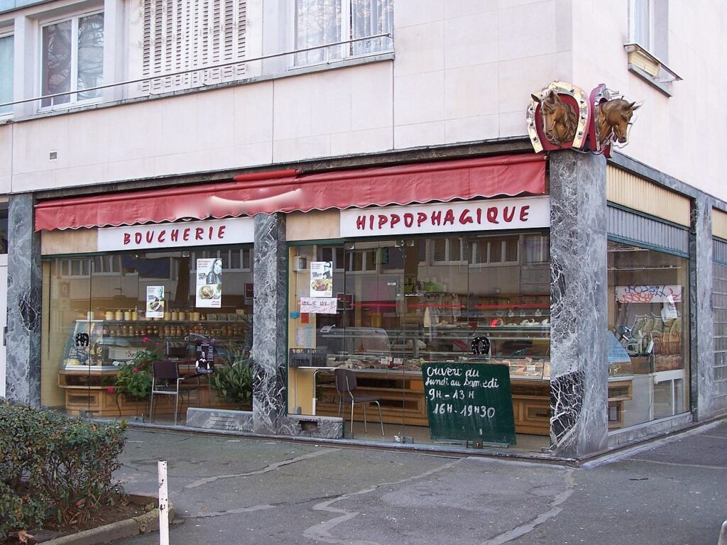 Boucherie Hippophagique in Paris outside of horse butcher with two horses head on corner