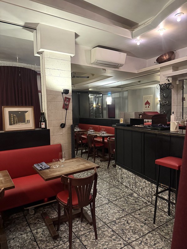 amarente restaurant Paris interior with chic modern feel: red chairs and stools tiled floor high ceilings