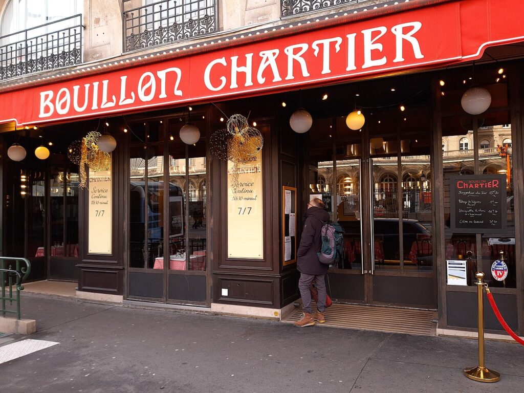 Bouillon Chartier Gare de le'Est entrance with awning with name, old fashioned wooden doors and windows
