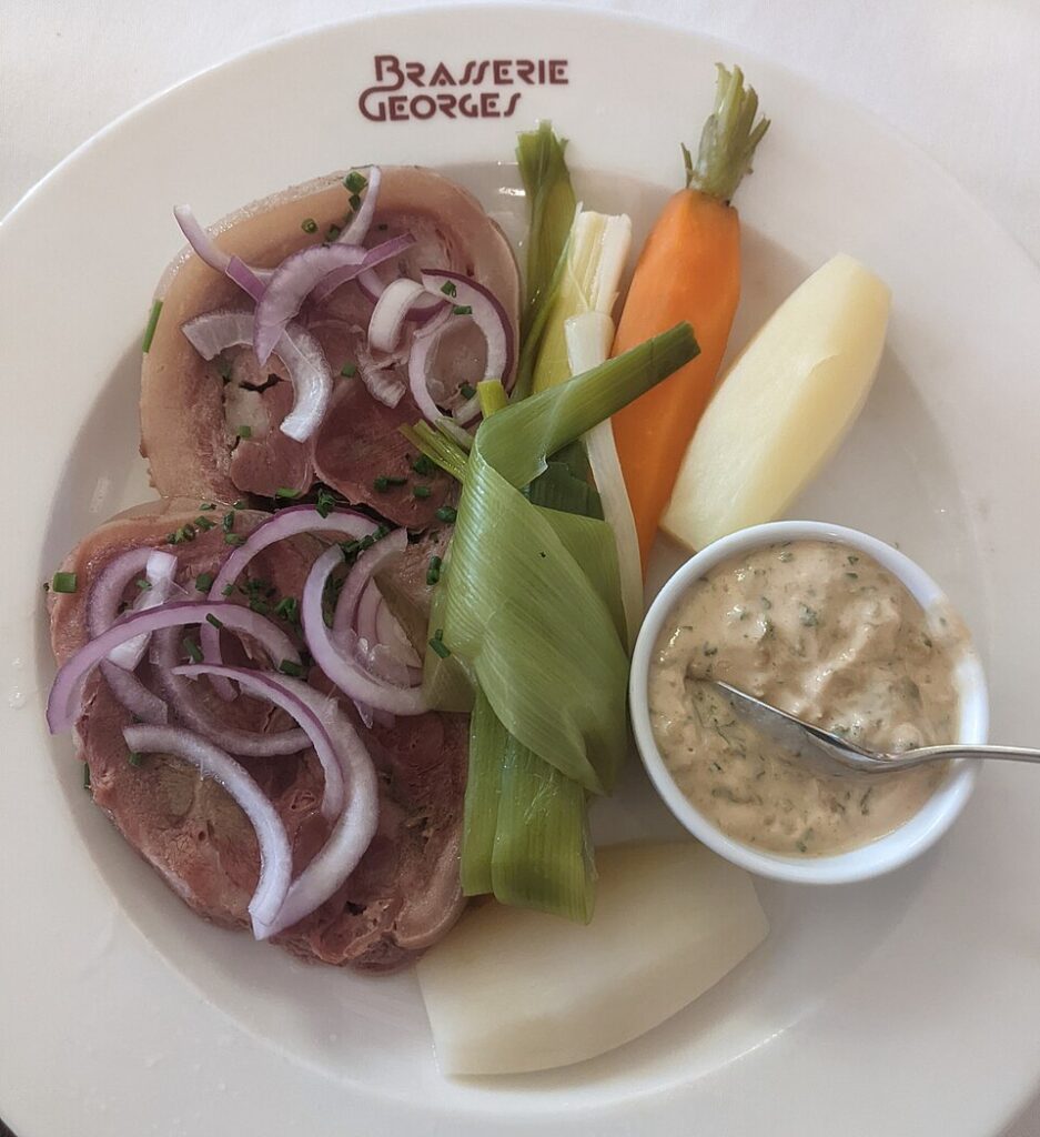 tête de veau at Brasserie Georges with plate of veal head, onions, carrots, sauce