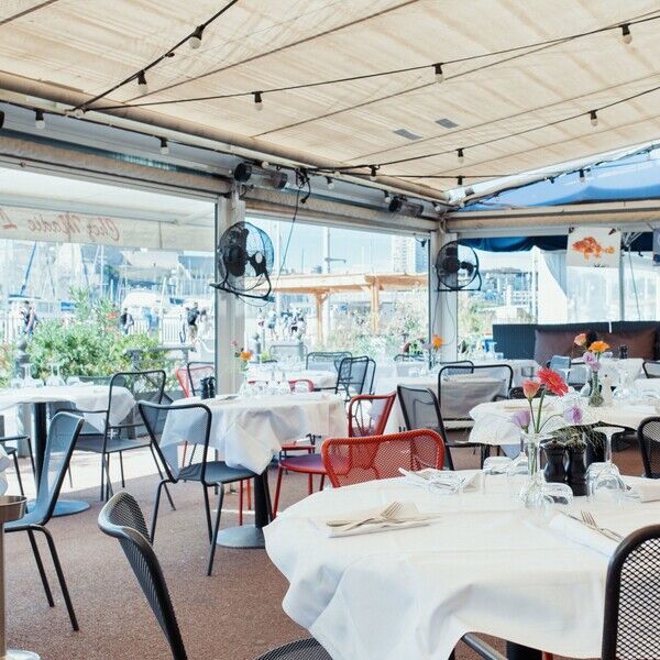 Chez madie les galinettes restaurant marseille showing covered terrace and tables and chairs and lookng out onto street