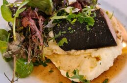 Andouille at Puteaux restaurant showing andouille on top of mashed potato