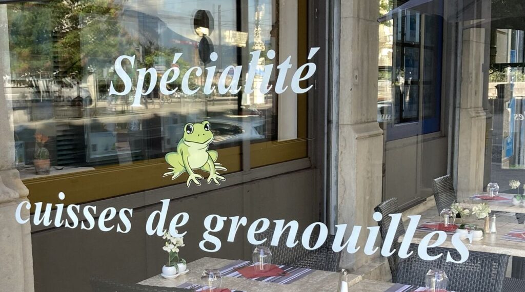 La Marmite Dauphinoise Grenovle window with Specialite de grenouilles on window and pictureof jolly frog