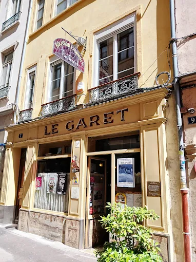 Exterior of Le Garet Lyon with words on brown sign above door, simple looking restaurant