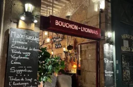 le Bouchon les Lyonnais from outside with big entrance door and blackboard outside with menu