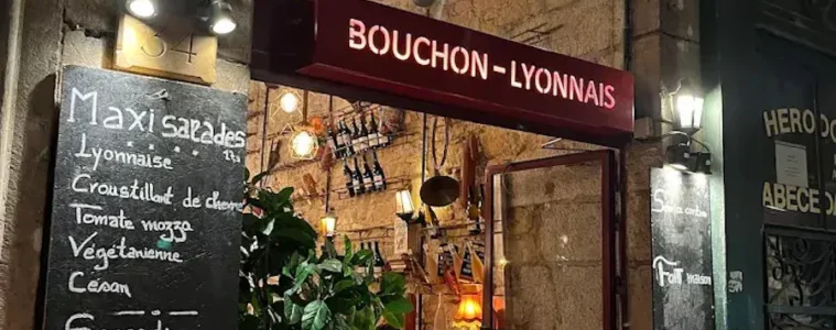 le Bouchon les Lyonnais from outside with big entrance door and blackboard outside with menu