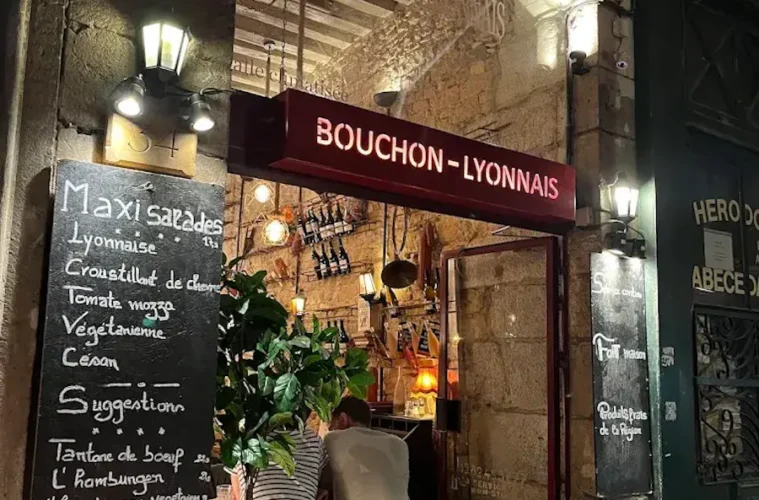 le Bouchon les Lyonnais from outside with big entrance door and blackboard outside with menu