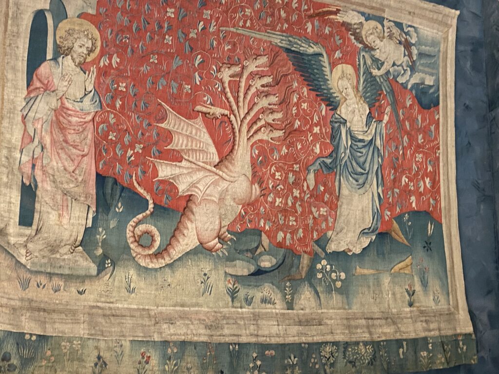 Apocalypse Tapestry with the 7-headed monster facing a winged figure 
