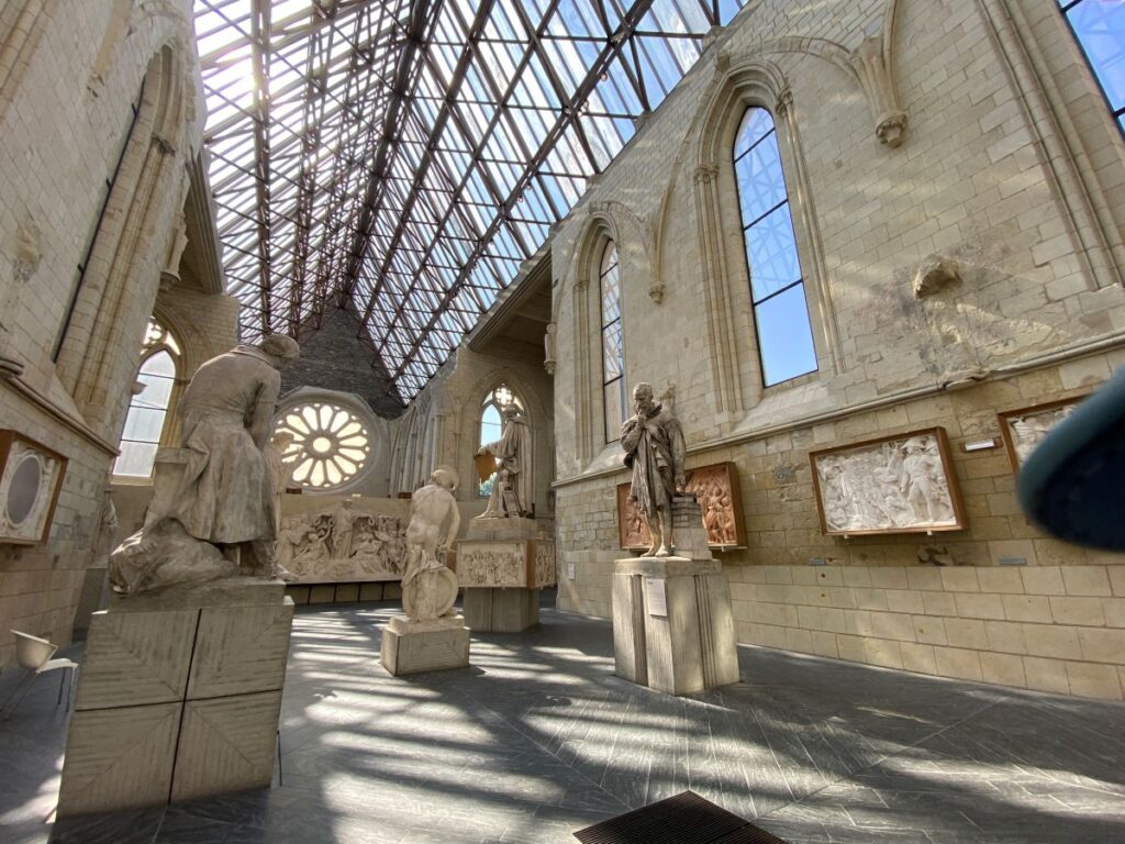David d'Angers gallery in huge church with steel and glass ceiling and his statues