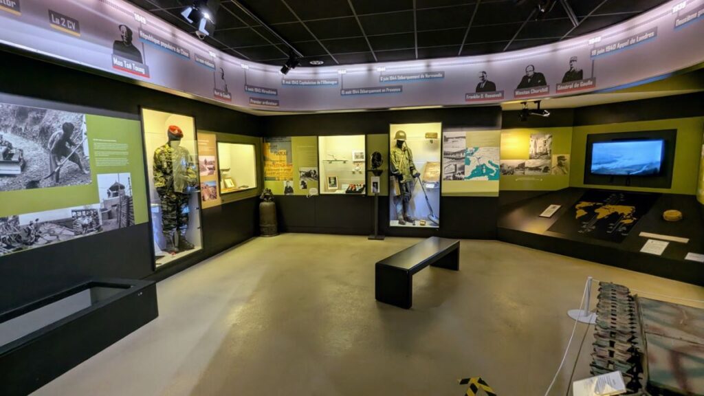 Museum of Military engineering Angers with L-shaped room, lit display cases and timeline running around top of room